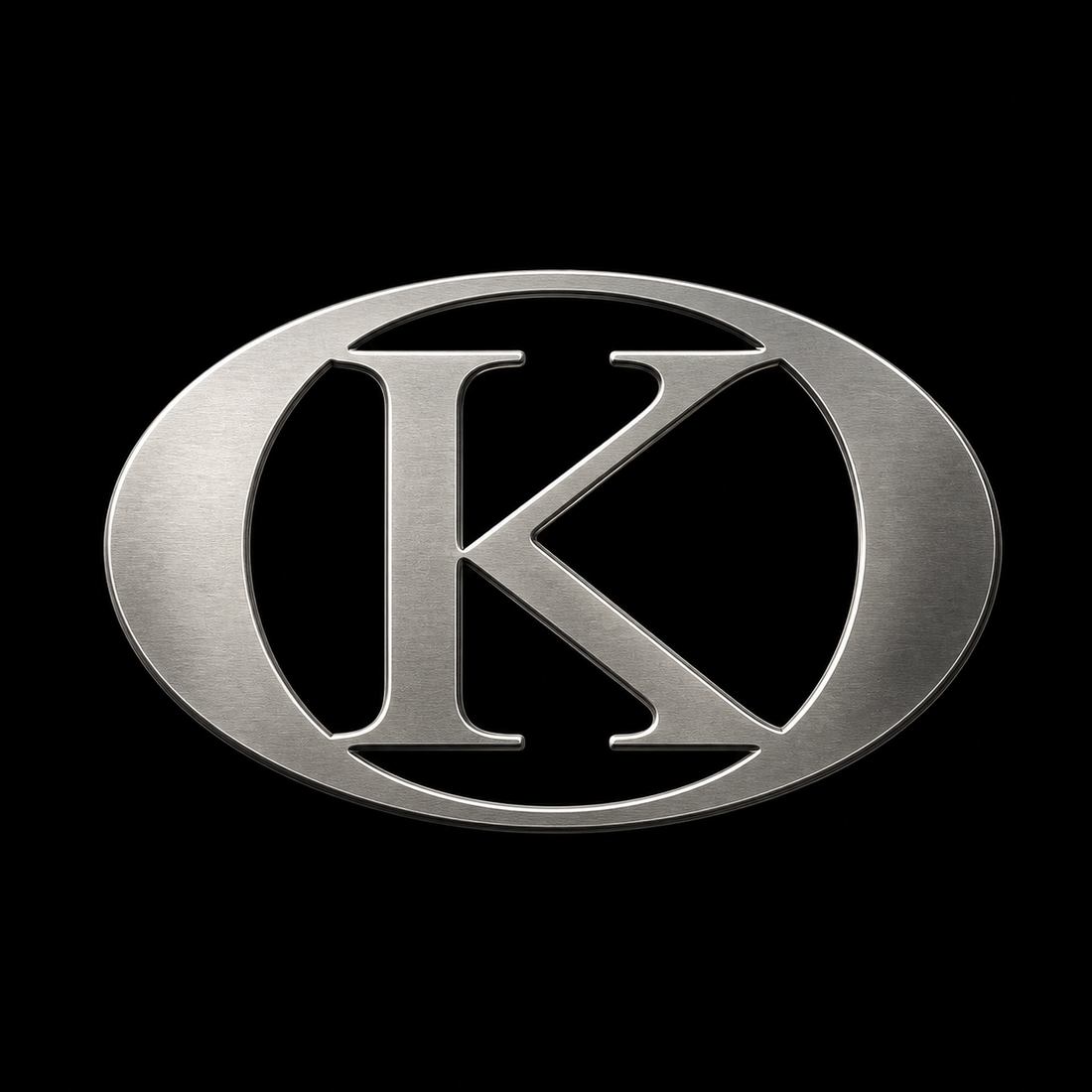 Platinum KORTONS oval K logo with brushed metallic finish centered on deep black background, featuring clean engraved edges and high-contrast luxury presentation.