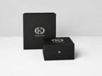 KORTONS luxury presentation box displayed before a matching signature packaging box on a clean light backdrop, featuring black semi-gloss finishes, refined proportions, and minimalist brand presentation.